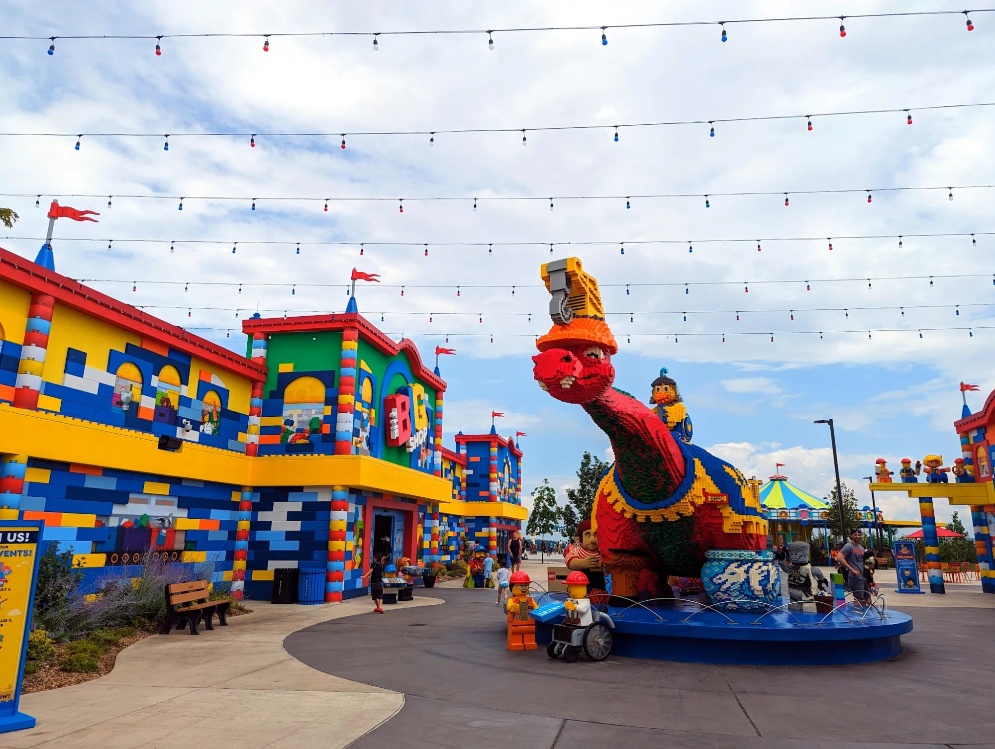 LEGOLAND® New York Resort featured image Colorful dinosaur sculpture among LEGO buildings at LEGOLAND New York Resort.