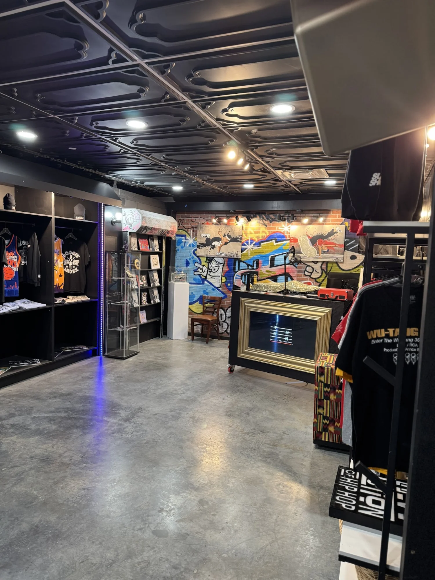 Interior view of The Culture Lab in Mott Haven, Bronx with vibrant mural and merchandise displays.